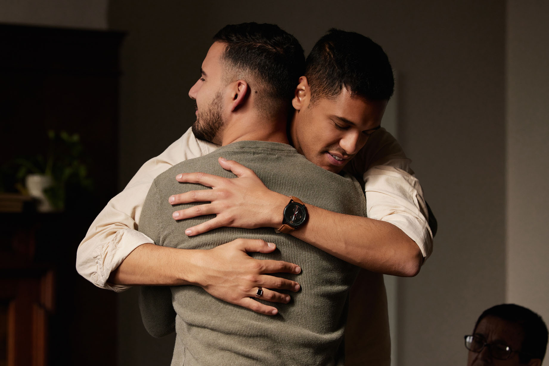 Two men embracing in a supportive hug, reflecting healing, emotional safety, and the power of connection in trauma recovery or relationship therapy.