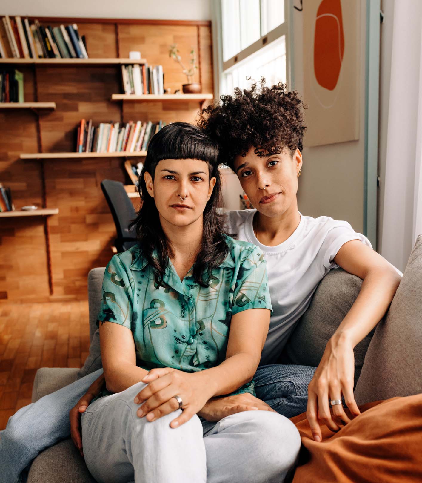 LGBTQ couple sitting together on couch in therapist's office, representing inclusive mental health counseling in Colorado Springs