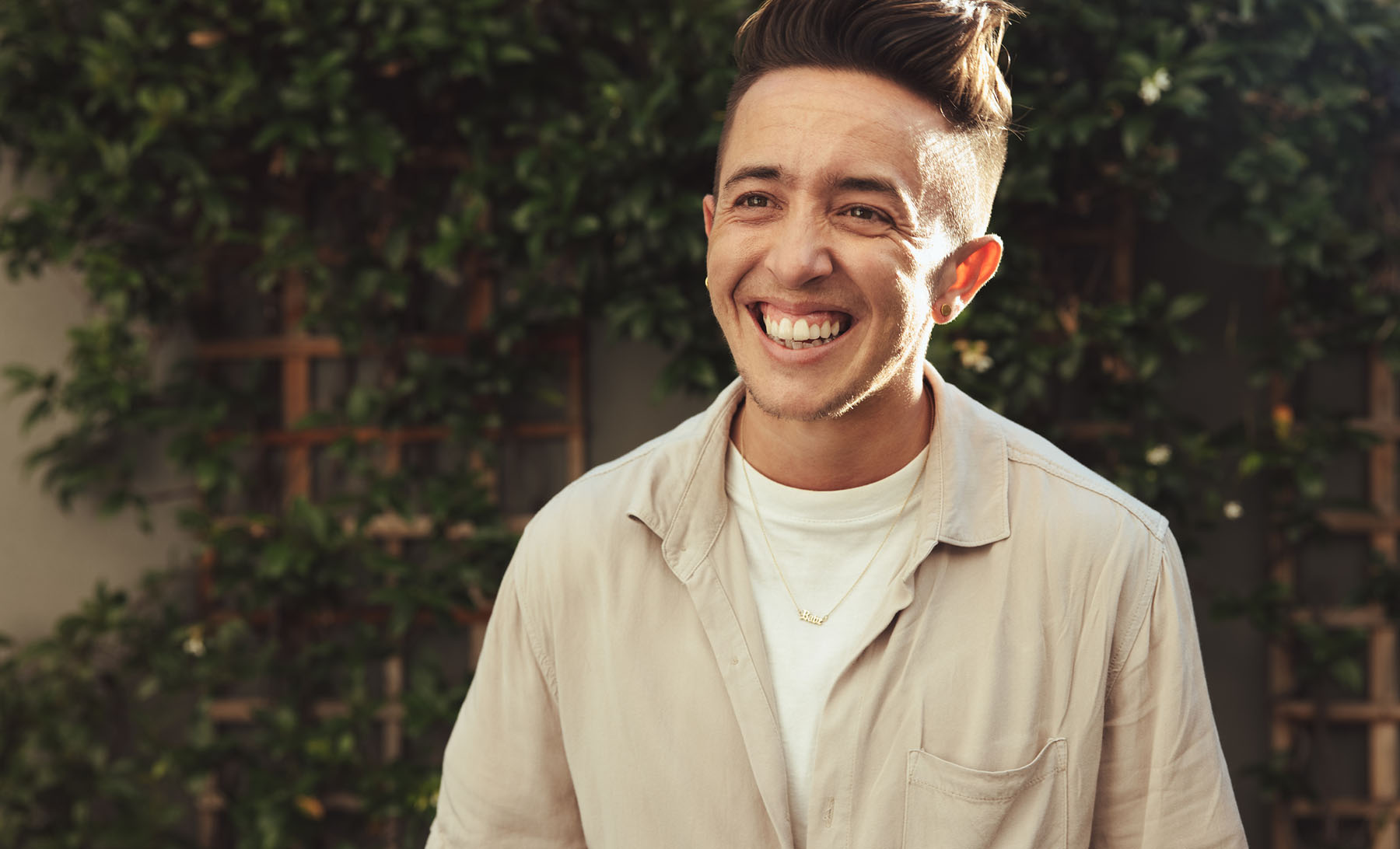 LGBTQ+ client smiling confidently outside after affirming therapy session, representing inclusive mental health care and gender-affirming support at Vivus Counseling