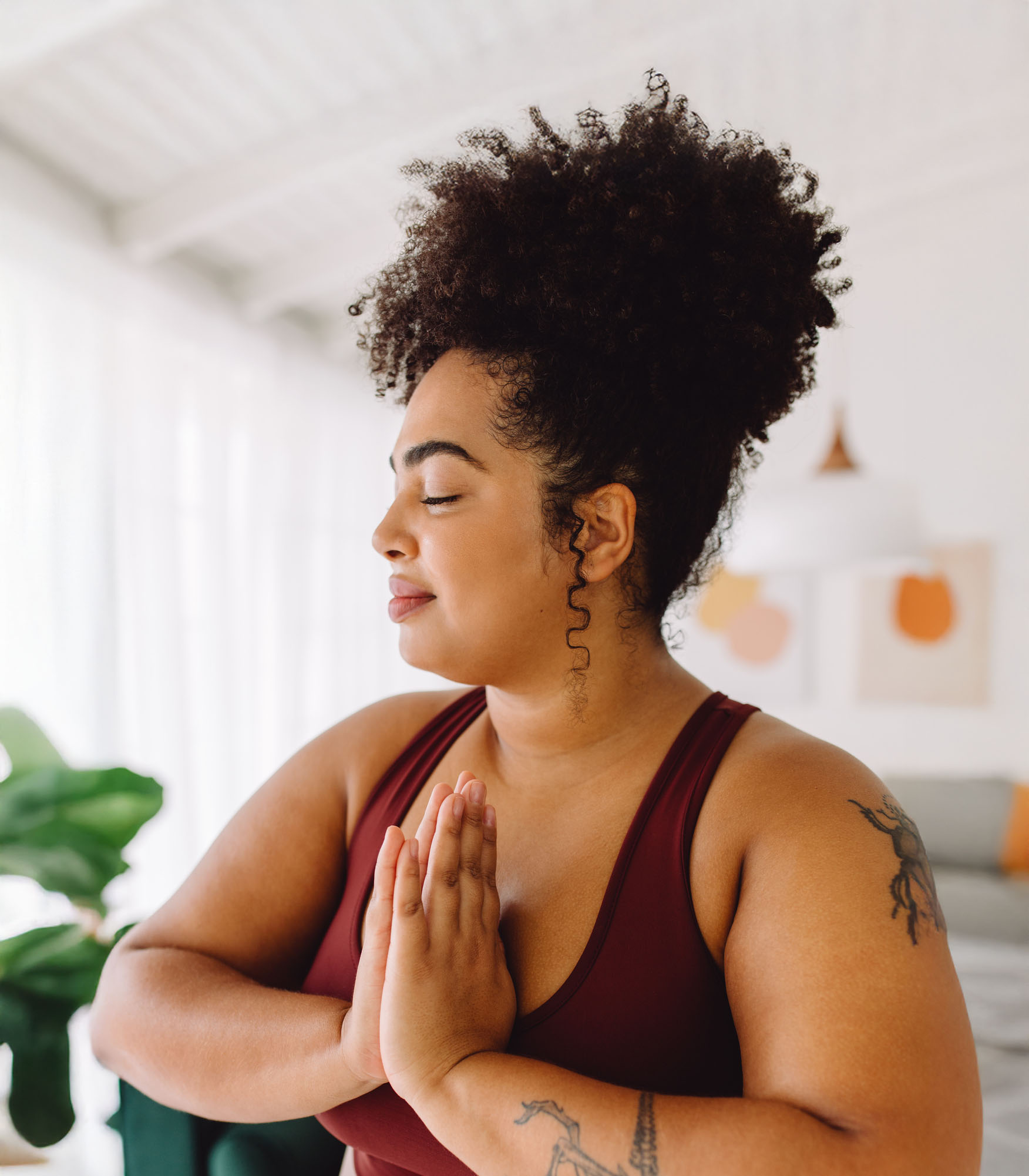Peaceful woman practicing yoga with prayer hands, illustrating the connection between physical well-being and emotional healing through therapy