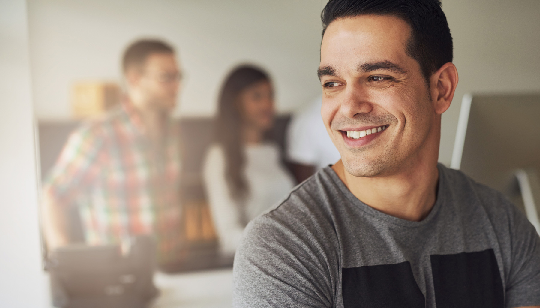 Smiling man in casual office setting representing confidence and emotional well-being supported by therapy at Vivus Counseling