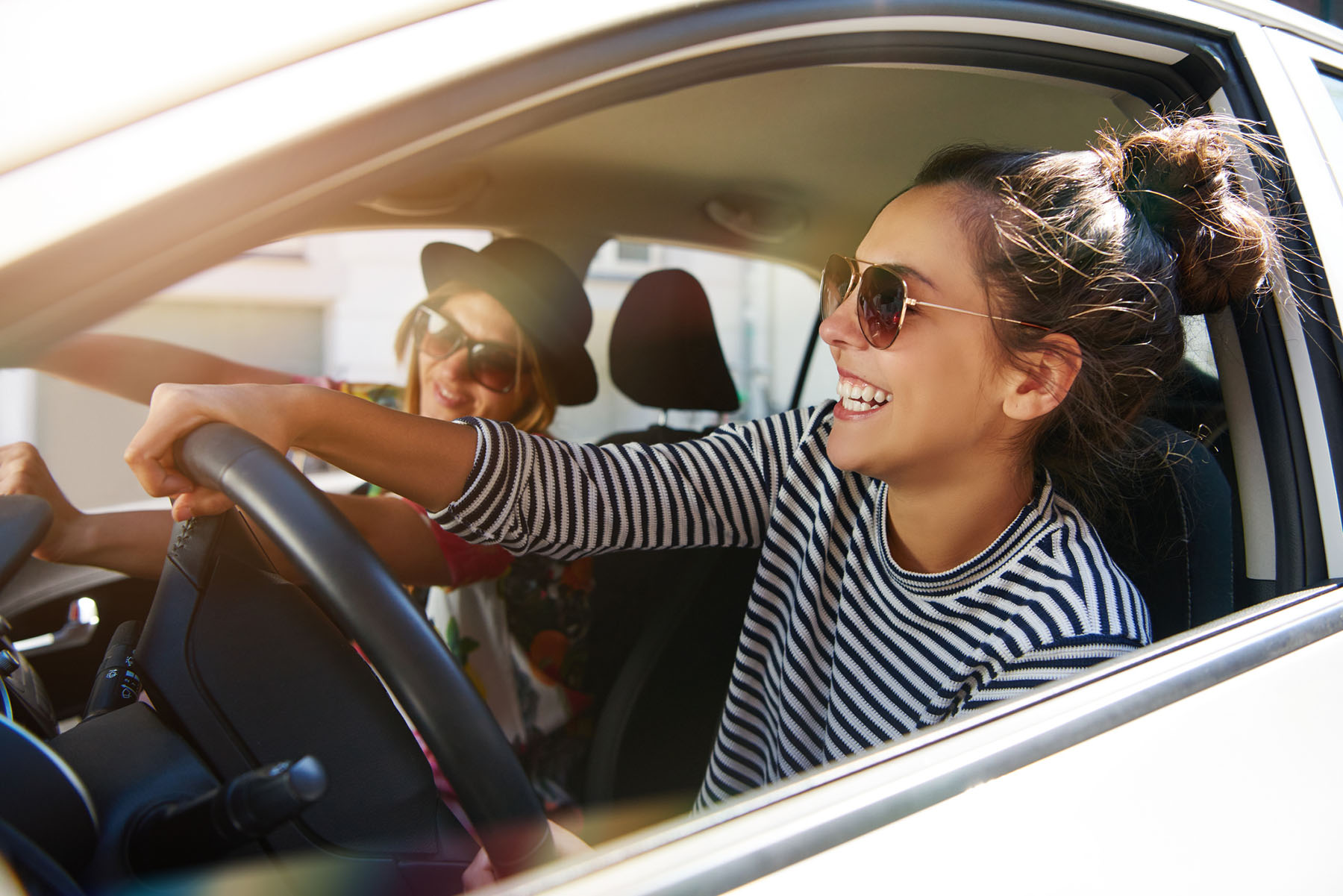 Woman smiling behind the wheel of a car, highlighting progress in DUI therapy and responsible decision-making